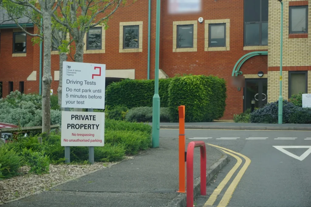 DVSA driving tests sign and a private property sign at an office entrance with give way markings
